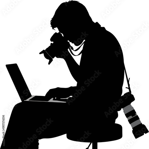 Professional photographer silhouette working on a laptop with cameras nearby