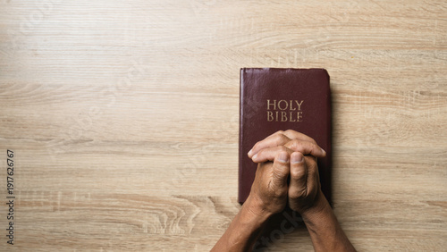Wallpaper Mural Old man hands clasped prayer with Holy Bible for Christian faith, spirituality, worship, devotion, hope, and religious belief, prayer time in church, trust in God, and spiritual guidance. Torontodigital.ca