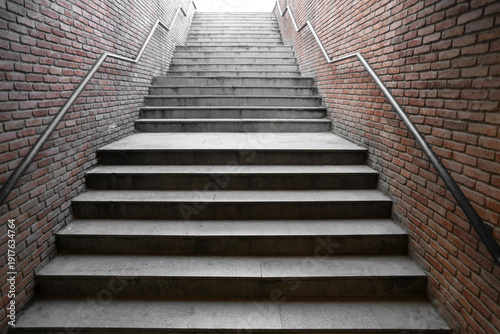 Konstfotografi new modern empty underground passage stone stairway descending into a brick-walled tunnel