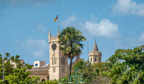 Behind lush tropical vegetation, the towers of the Parliament Buildings, Bridgetown, Barbados