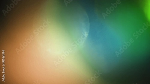 light leak and bokeh overlay with swirling green and orange hues. This footage is perfect for adding a creative visual element to videos.