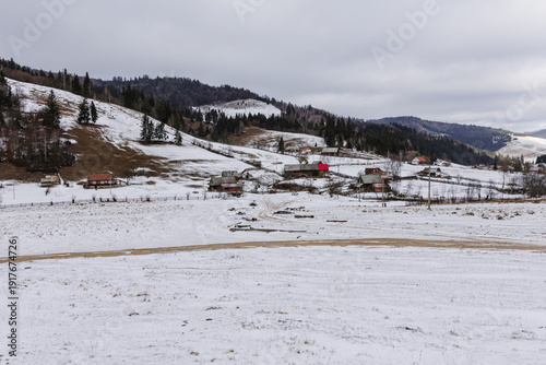 Snow covered rural village in mountain landscape