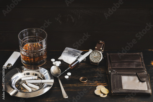 Tableau sur toile Drug and alcohol addiction concept with heroin syringe, cocaine, pills and weddi