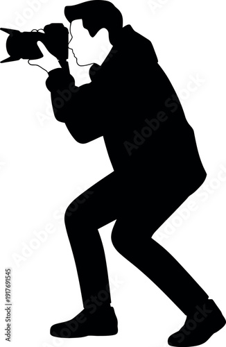 Silhouette of a photographer taking a picture Keywords: photographer, silhouette, camera