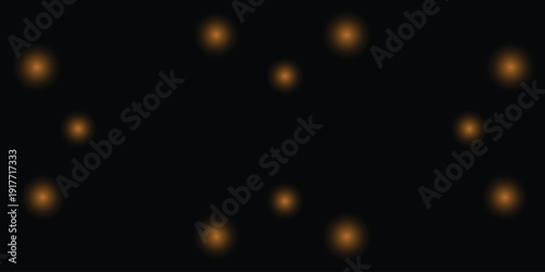 Blurry orange lights on a black background resembling a night sky or abstract art piece with multiple glowing orbs