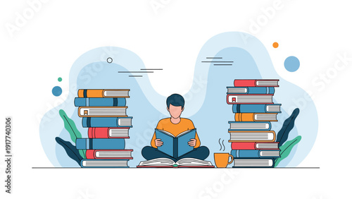 Young man sitting cross-legged on the floor and reading a book between two very tall stacks of colorful hardcover books.