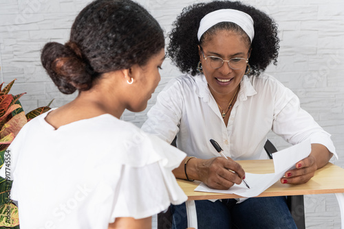 Mother helping student writing university acceptance letter