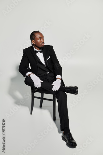 Bild auf Leinwand Elegant young man in stylish tuxedo showcasing fashion and charm in a modern set