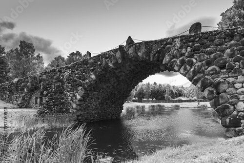 Wallpaper Mural The Boulder Bridge of Vasilevo, Russia. It is a hundred-meter arched bridge with grottoes, made using the archivolt technique. Black and white photo featuring beautifully crafted historic stone bridge Torontodigital.ca