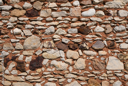 Rustic stone wall with red concrete texture background with natural stone pattern