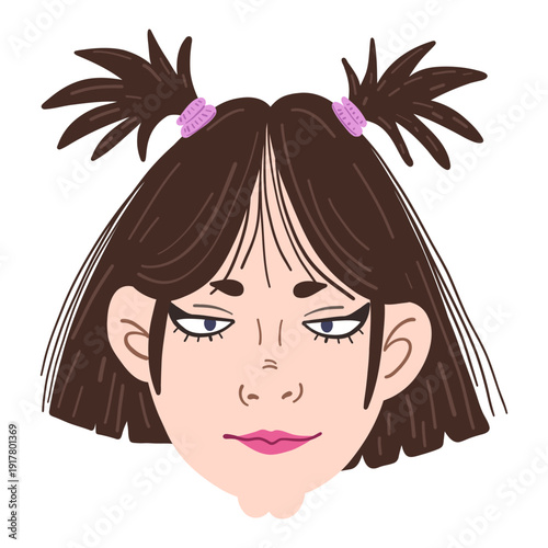 A young girl with dark brown hair has her hair styled in two pigtails. She has a focused expression with a touch of attitude. The background is simple and does not distract from her face