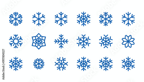 Collection of blue snowflakes in various shapes and designs on a white background