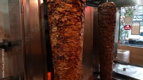 Shawarma Meat Rotating on Vertical Grill – Traditional Middle Eastern Food