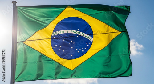 Brazilian Flag Waving In The Blue Sky Sunlight
