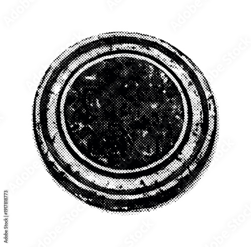 An old rubber ink stamp viewed from above, circular stamping surface emphasized as a graphic