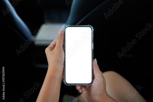 Foto Close up of a woman's hand using a smartphone in the car