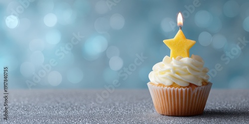 Vanilla cupcake with star candle against sparkling blue background