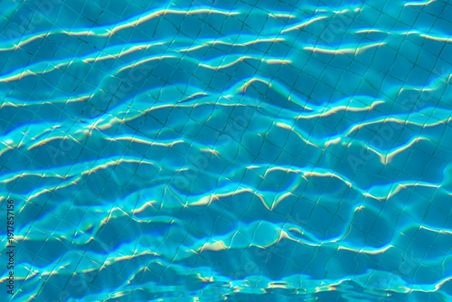 Turquoise pool water with sunlight reflections