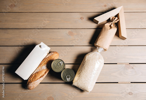 Grocery items including rice, bread, canned goods, and milk form an arrow shape