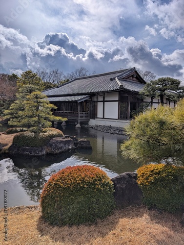 Фотография Beautiful traditional Japanese garden with a peaceful pond, wooden tea house, ma