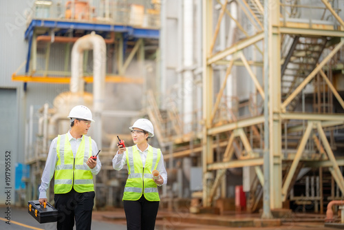 Asian male and female engineers from the company oversee corrective maintenance work at large power plants, ensuring the continued growth of the energy industry.