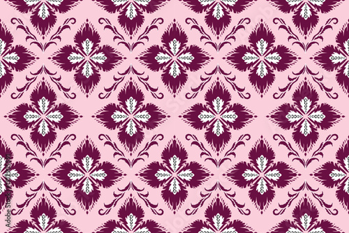 Elegant seamless damask floral pattern with burgundy ornamental motifs on soft pink background. Vintage inspired decorative design featuring symmetrical classic elements and int