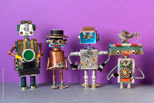 Four toy robots of different designs: copper, metal, plastic, with gears, circuit boards, wires and radio components standing in row. Tech toy concept, future technology poster, gadget banner