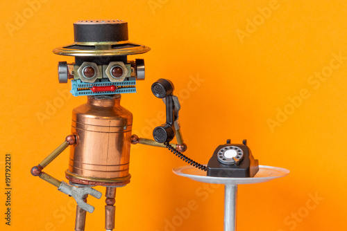 Vintage copper robot wearing hat with rotary telephone handset. Hotline operator concept, customer service flyer, helpdesk leaflet