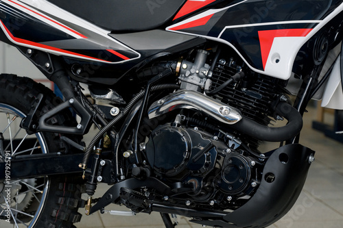 Detailed view of the motorcycle engine with chrome exhaust pipe.