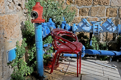 View of blue pipes and plastic chairs