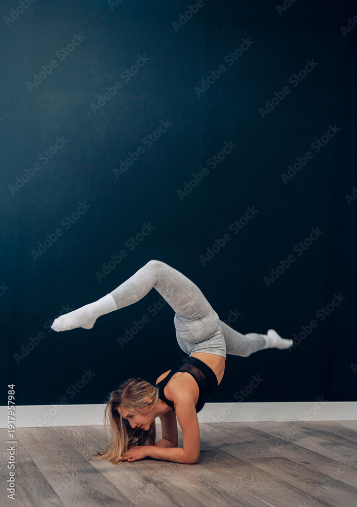Obraz premium Portrait Of Beautiful Young Female Doing Stretching, Girl Exercising and Enjoying Fitness Training And Healthy Lifestyle. Yoga for healt.