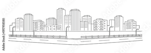 City skyline behind road with street lamps and guard rail