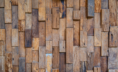 background consists of continuous wooden wall panels in a straight line.