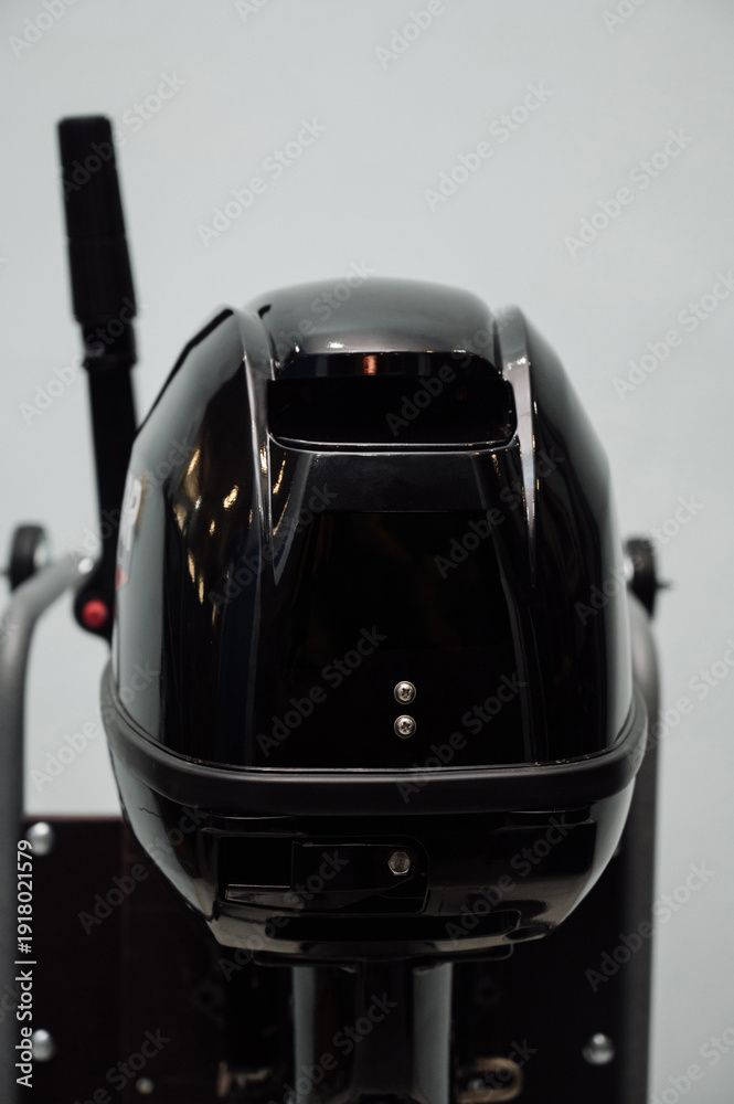 Fototapeta premium Outboard motor in the showroom: close-up of the hull and tiller.