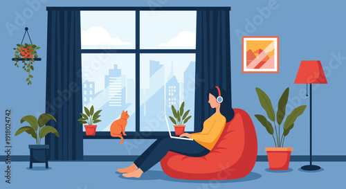 A woman in headphones works on her laptop from a cozy bean bag chair at home, with a cat by the window and plants surrounding her.
