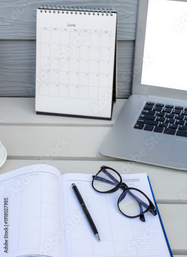 Calendar Planner book to plan reminder for daily appointment timetable, appointment, organization, and meeting agenda for job on wooden desk and working from home-banner image-vertical image.