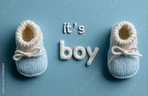 It's a boy, white text on a blue background, baby shoes and cute knitted booties.