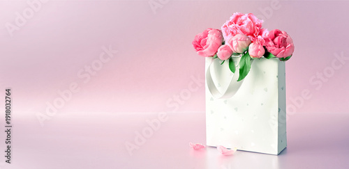 Beautiful gift box with pink peonies. Concept of internet shopping, flower shop. Mothers or Women's Day.