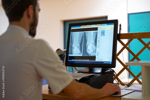 Foto Service radiologie médical manipulateur controle radio cheville sur écran ordina