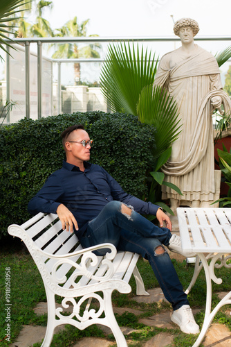 senior man sitting on a bench in a park