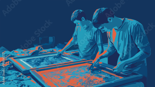 Two young men in blue and orange hues work on patterned screens