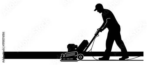 Construction worker using industrial floor grinding machine for concrete finishing