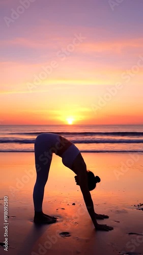A woman practices yoga and stretches on a serene beach during a vibrant sunset.