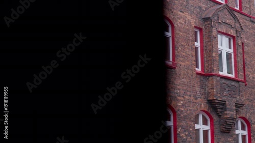 Red brick tenement house elevation. Red window frames. Old workers' housing estate. Unique architecture. Katowice Nikiszowiec. Poland