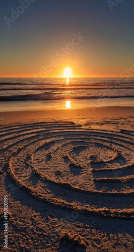A sunlit spiral in the sand on a beach as the sun sets over the ocean