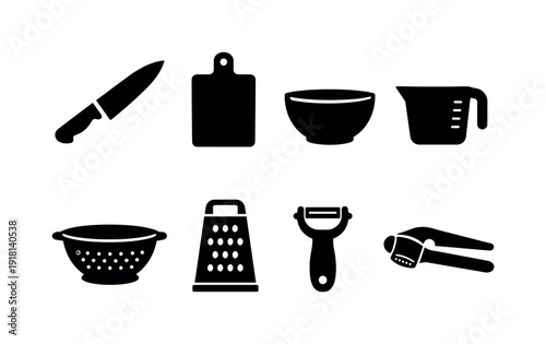 Kitchen food preparation set: chef knife, cutting board, mixing bowl, measuring cup, colander, grater, peeler, garlic press