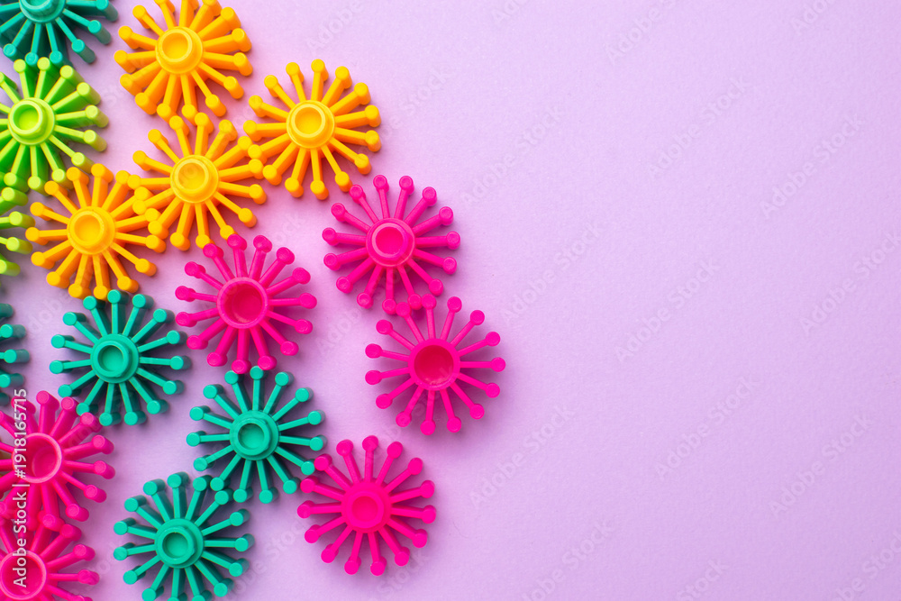 Obraz premium Colorful Plastic Sunburst Shapes on Pink Background for Creative Designs
