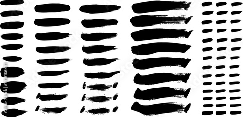 A collection of various black brush strokes and dots on a white background