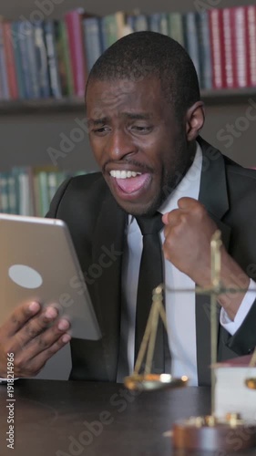 Wallpaper Mural African American Lawyer Celebrating Success on Tablet in Office, Vertical Video Torontodigital.ca