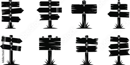 Set of wooden directional signs on grassy posts  various orientations and shapes